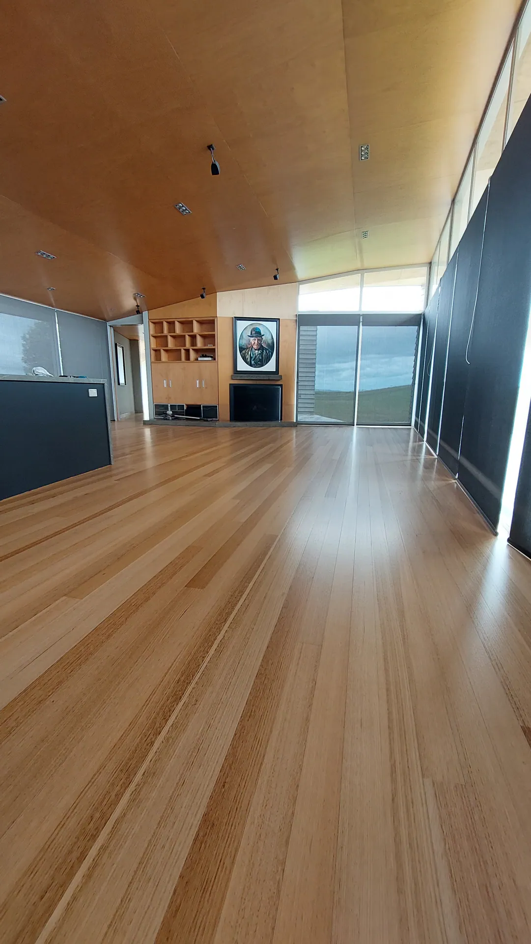 Blond timber floor along a window wall.