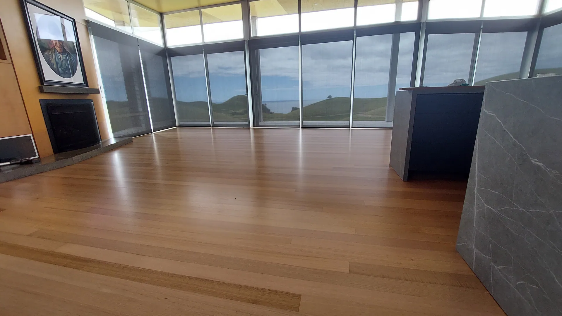 Blond timber floor in a long living room.