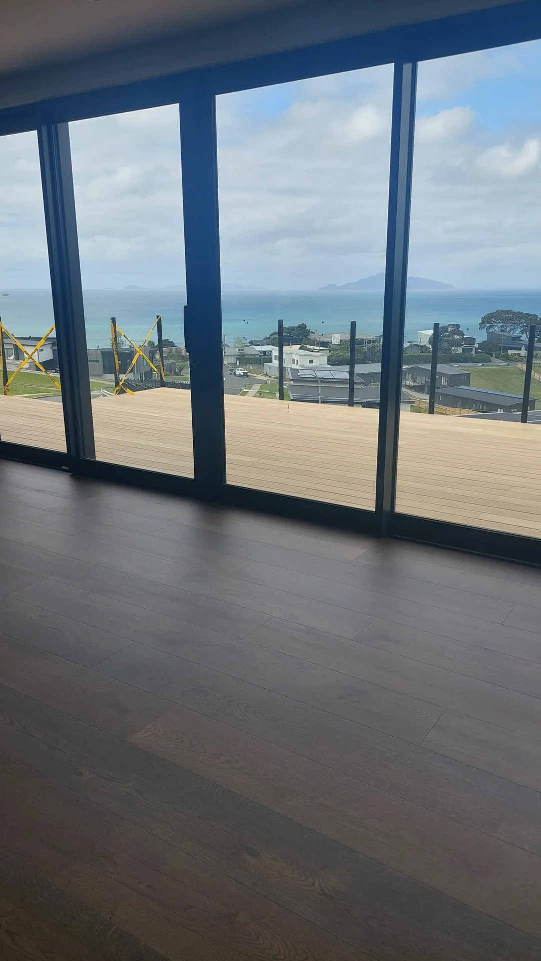 Dark floor facing big windows to the sea.