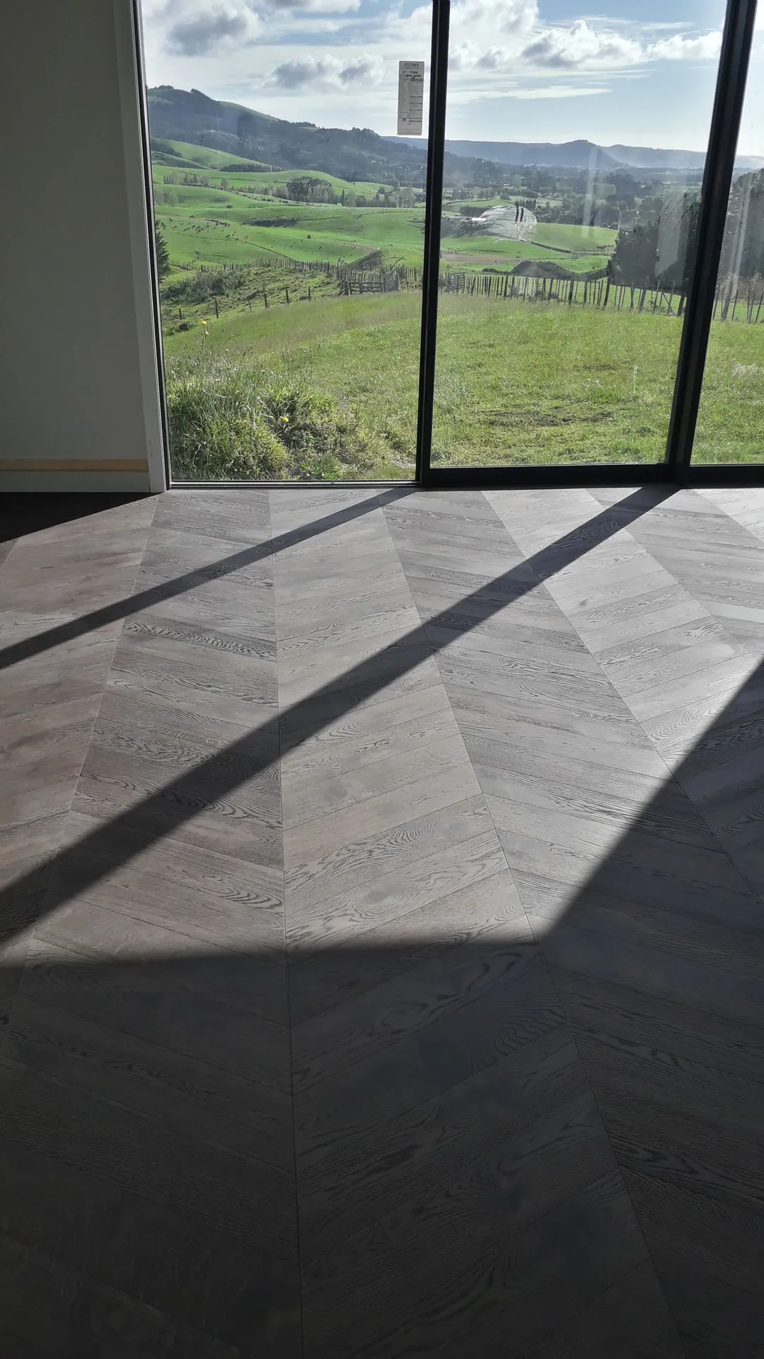 Dark herringbone floor with rural views.