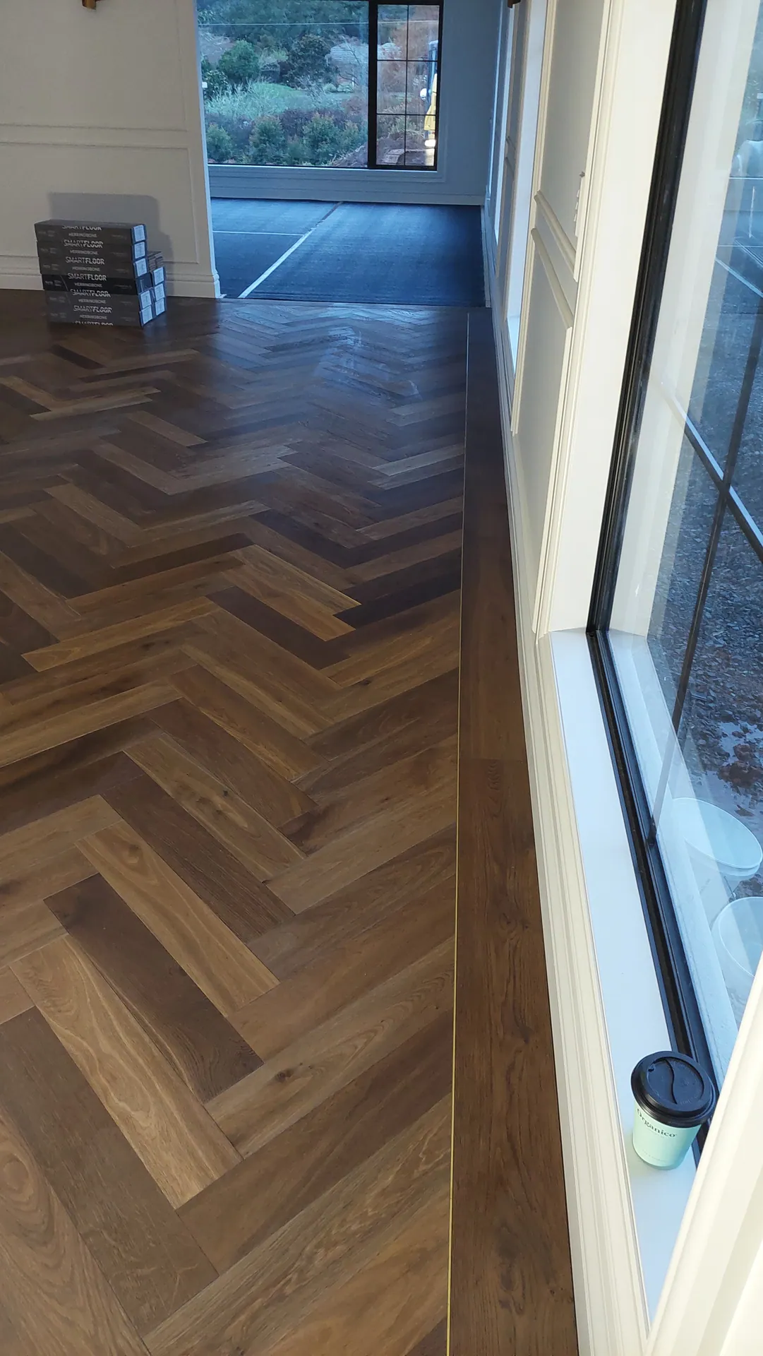 Dark oak herringbone going down by a window.