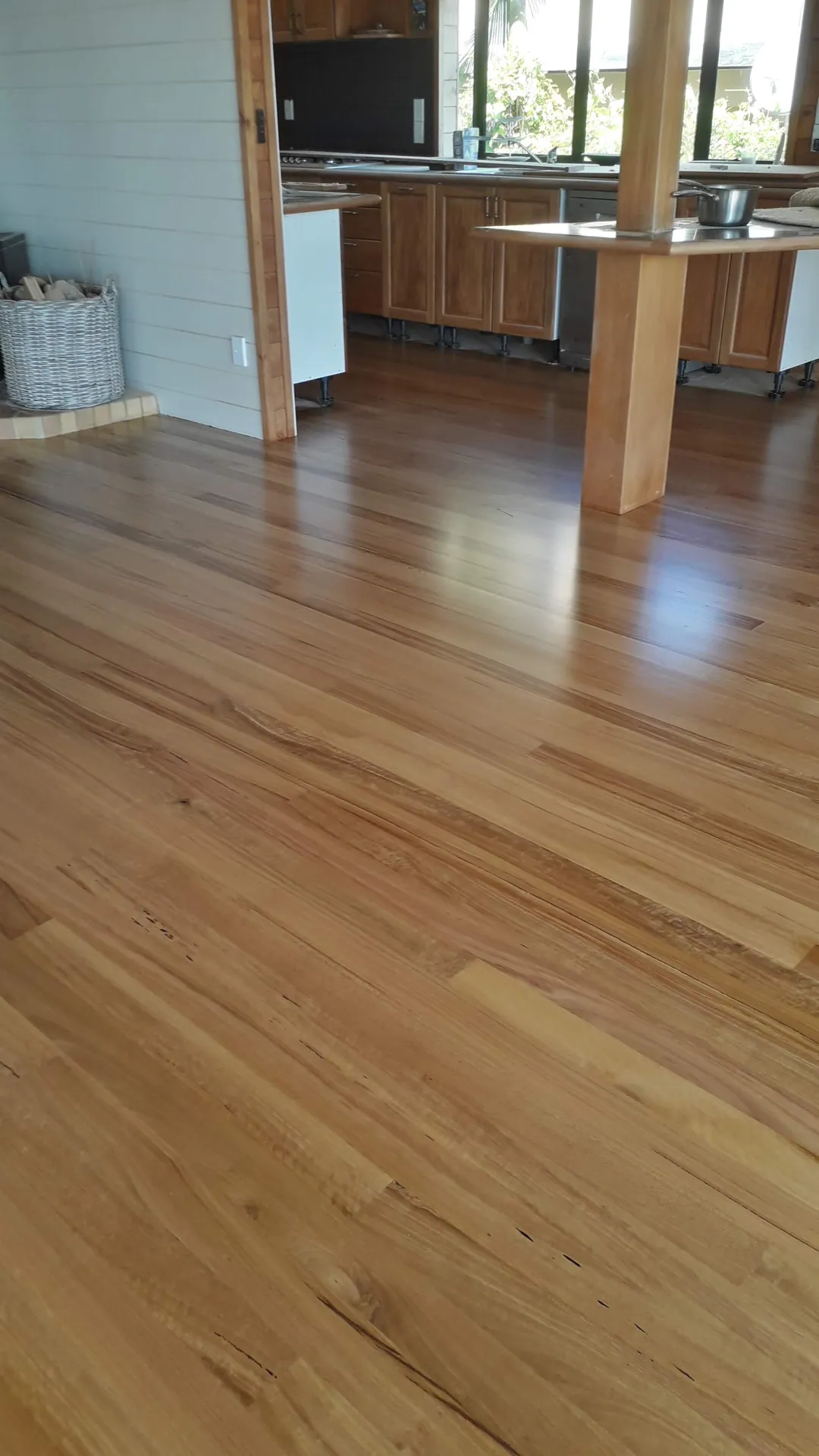 Golden timber floor in a kitchen and dining area.