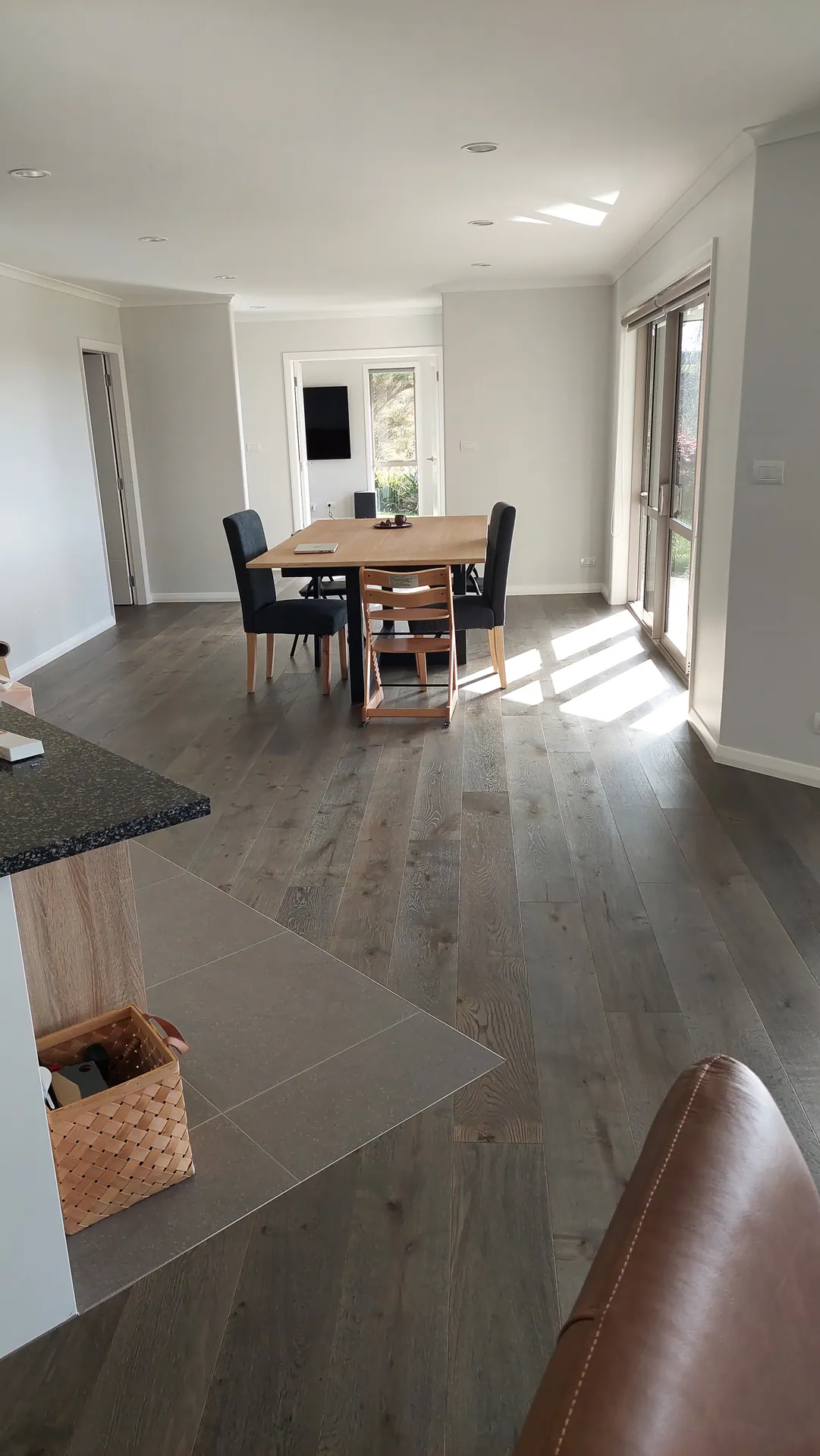 Grey timber floor in a dining area.