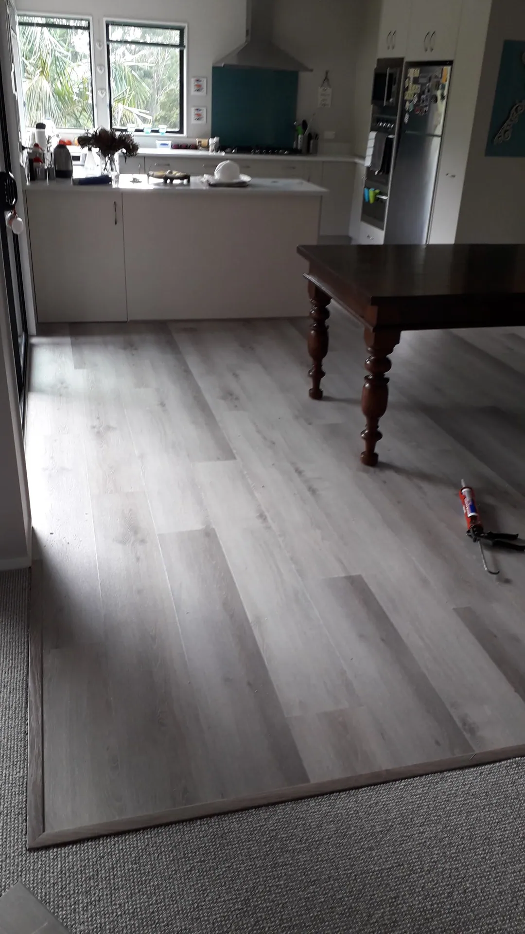 Light grey floor in a kitchen and dining room.