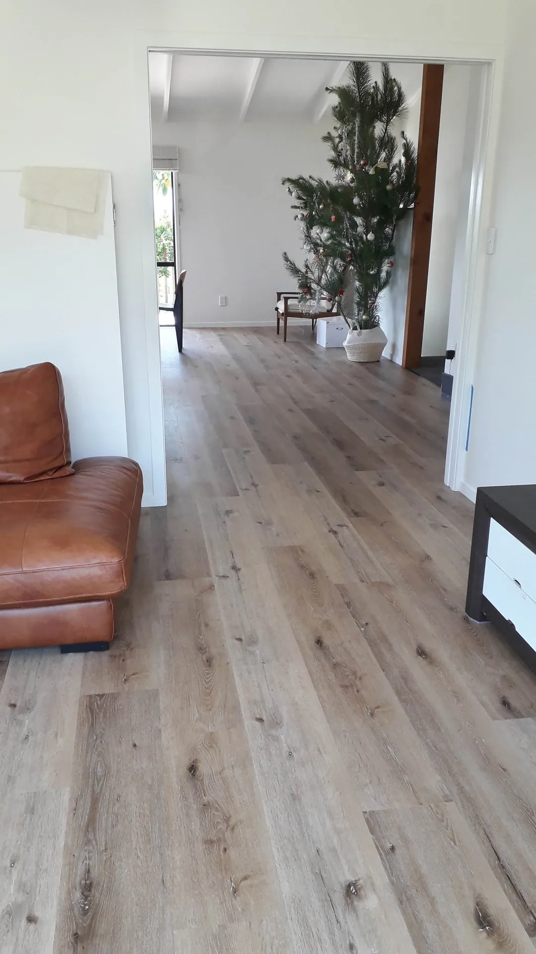 Light grey oak floor through a living area.