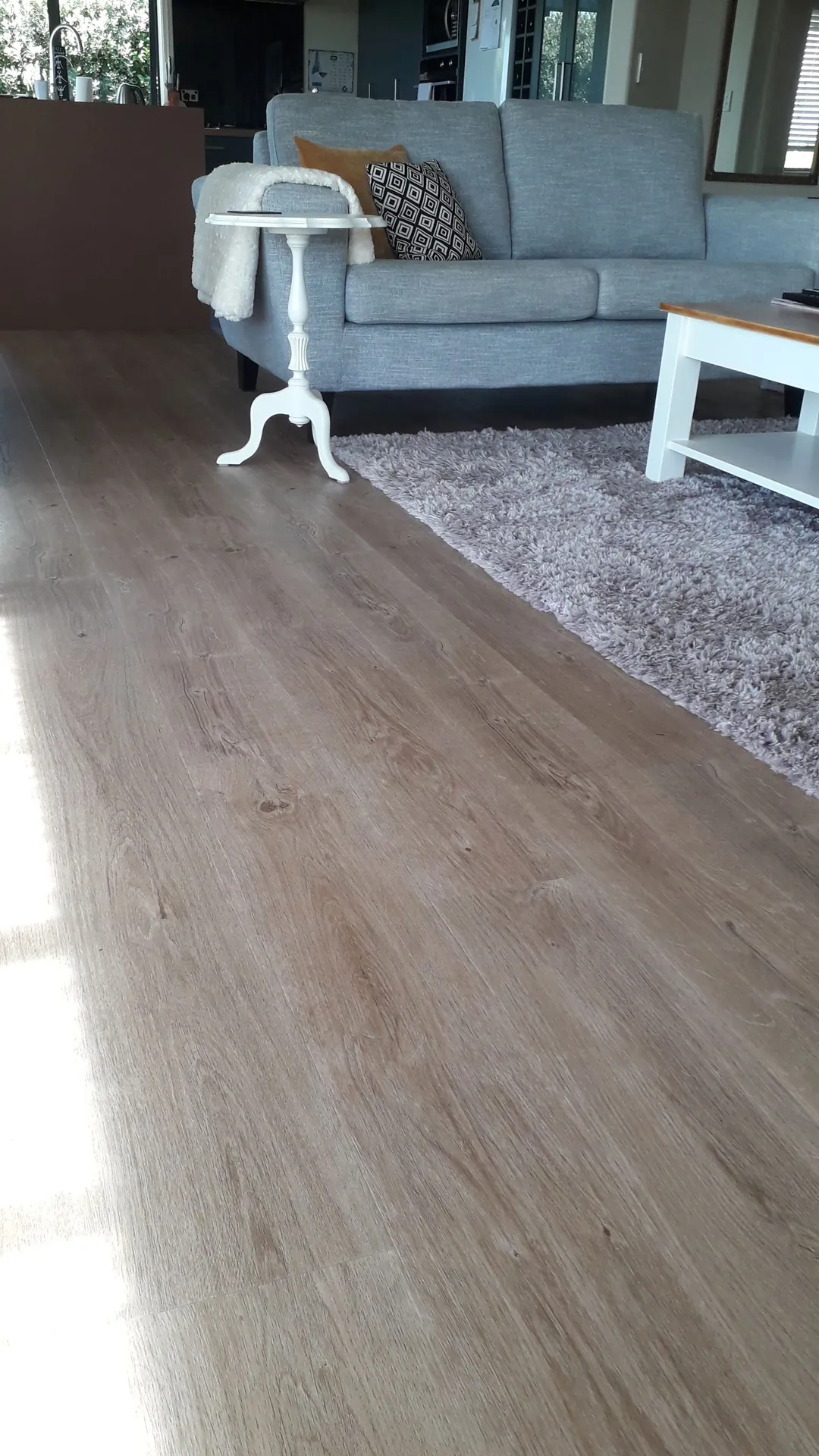 Mid-tone timber floor in a lounge.
