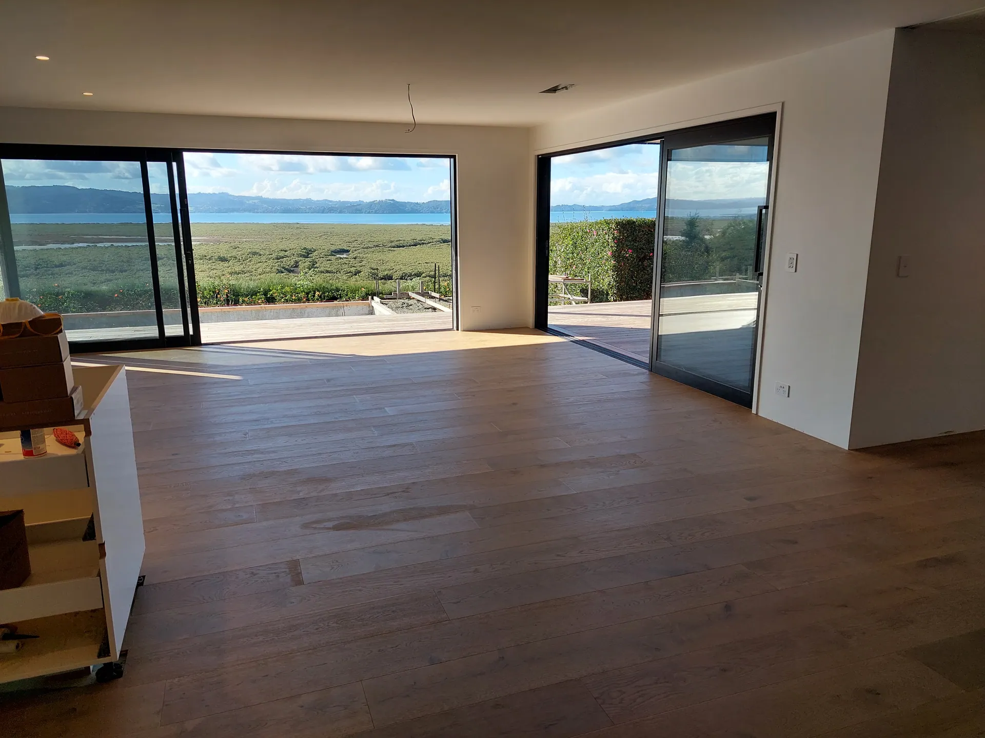 Oak floor in a living room with water views.