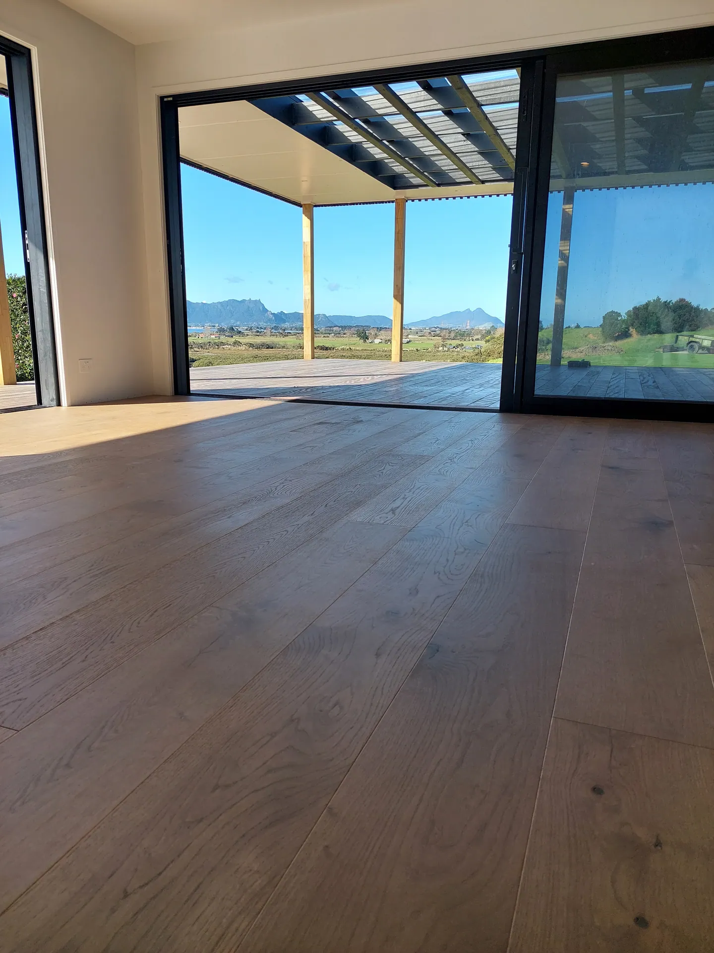 Oak floor out to a veranda with mountain views.