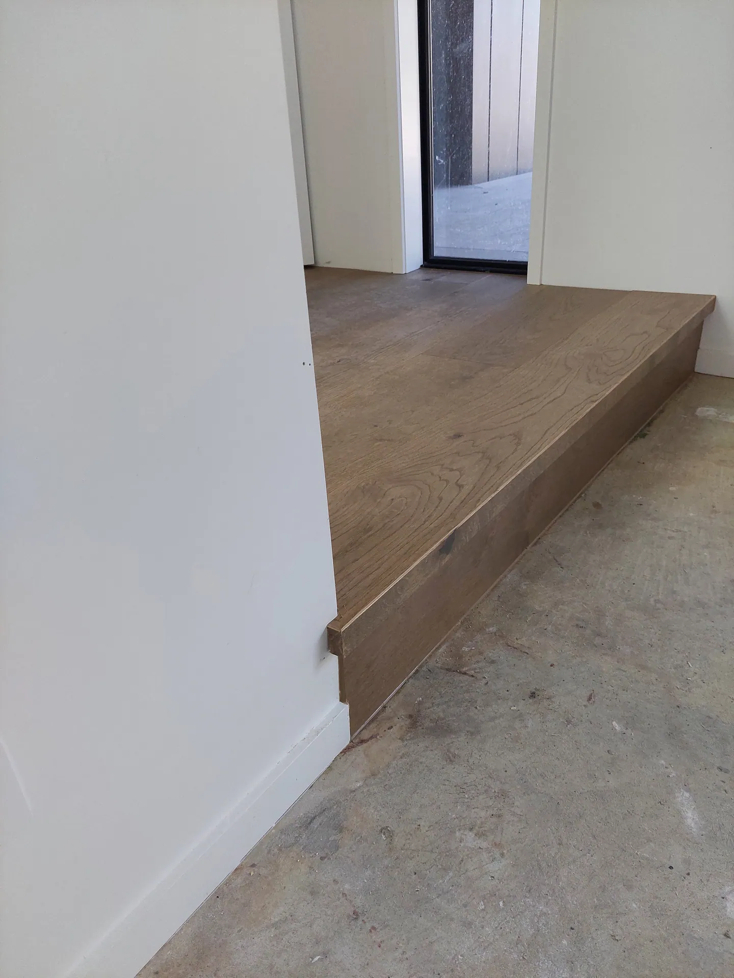 Oak step edge at a doorway.