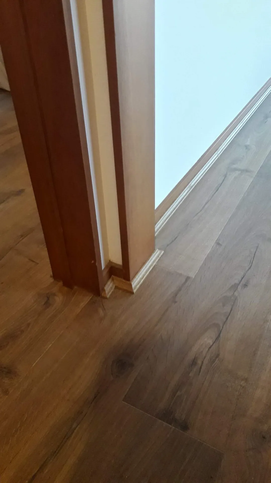 Timber floor meeting a door frame.
